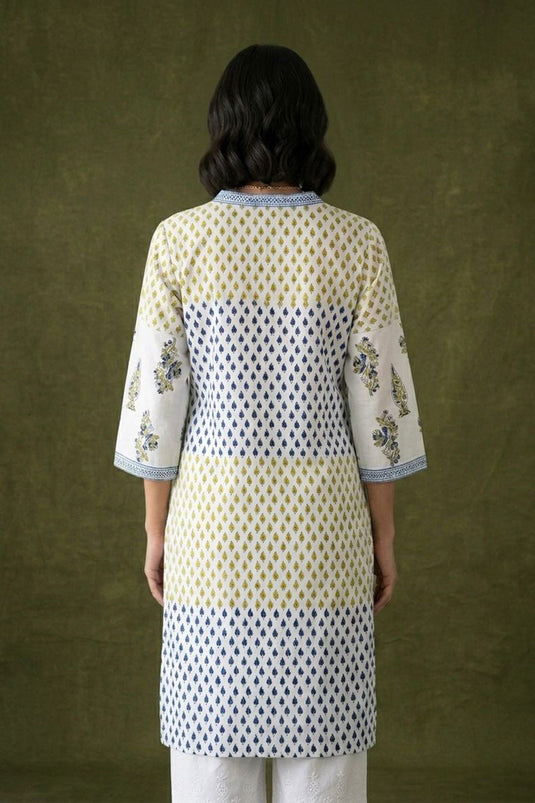 White kurta with scattered booties paired with chikankari pants